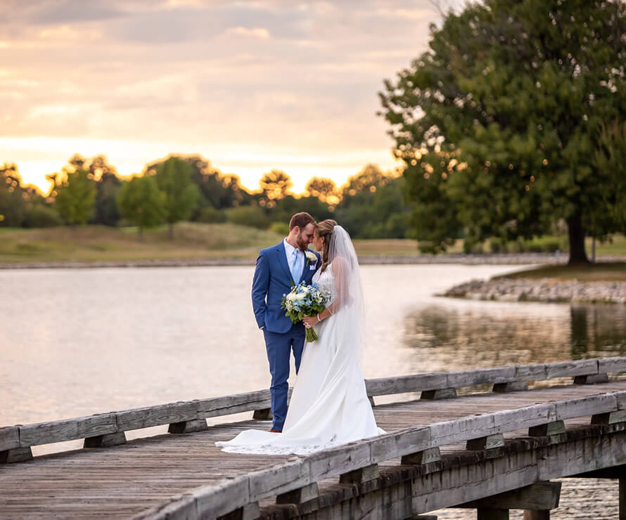 bride and groom on wooden bridge